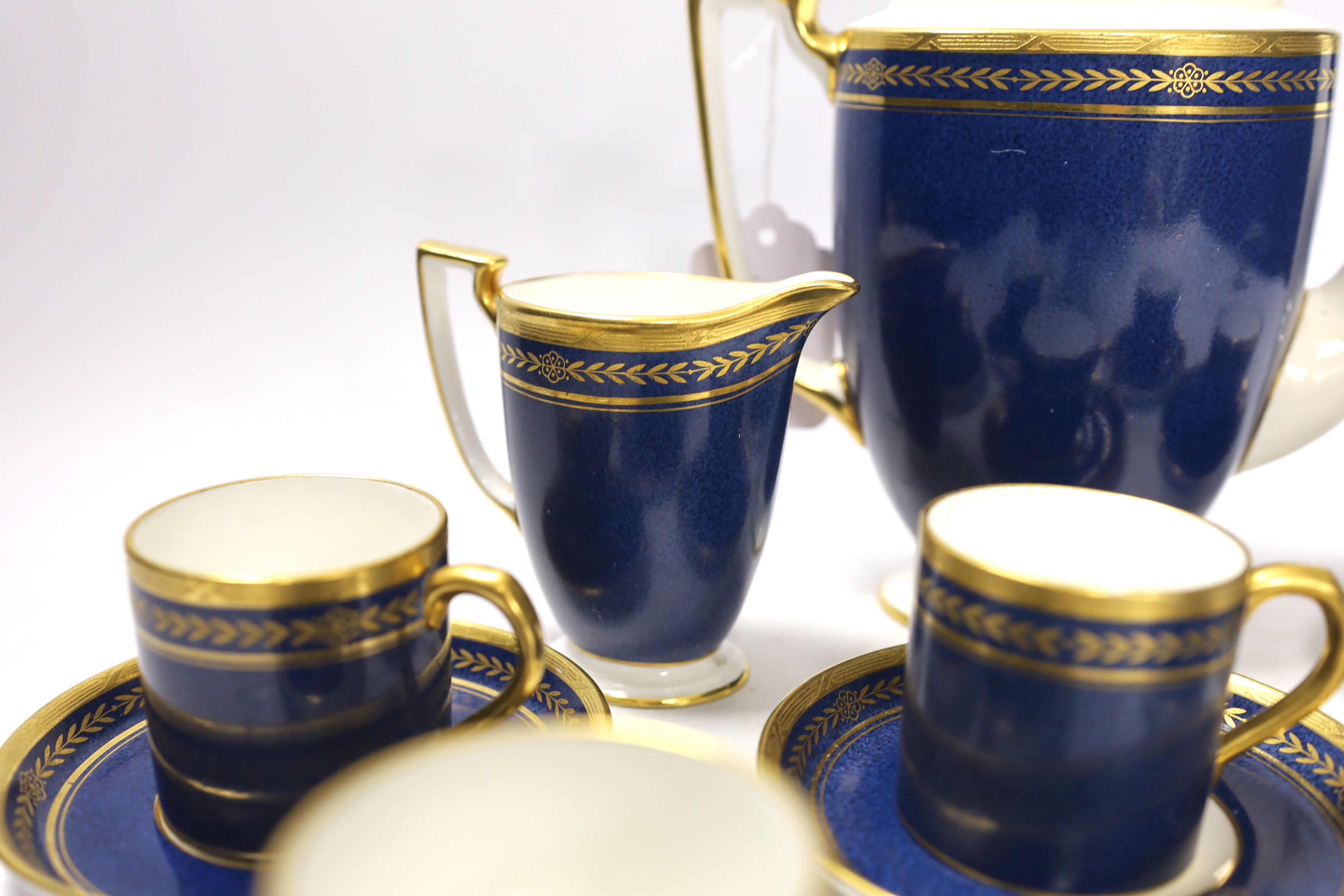 A Mintons powder blue part coffee set comprising six cans and saucers, coffee pot and milk jug together with a Staffordshire flat back figure group, 20cm wide